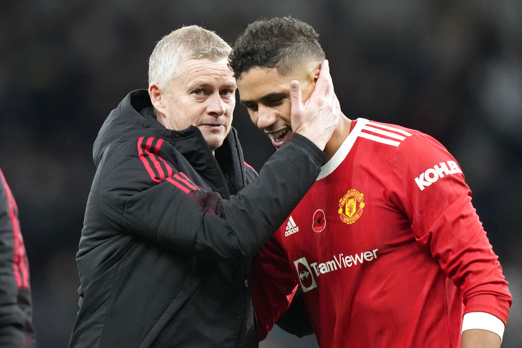 Manchester United's manager Ole Gunnar Solskjaer, left Raphael Varane